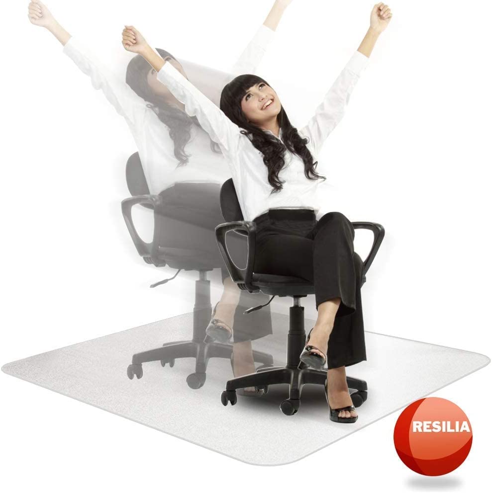 Woman in a chair on a clear chair mat with her hands in the air