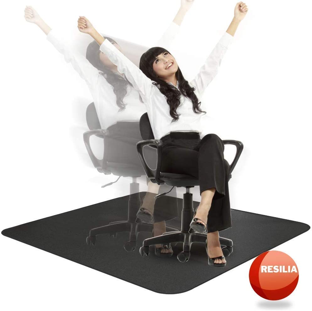 Woman in a chair on a black chair mat with her hands in the air