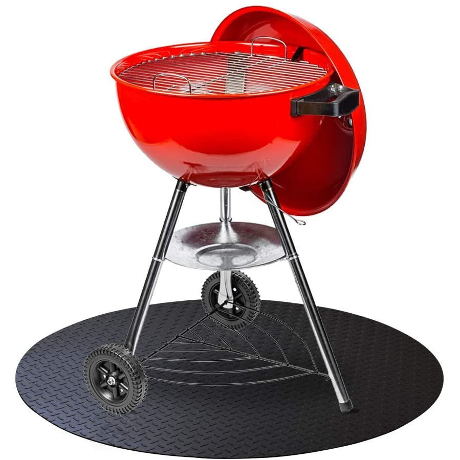 Smaller red charcoal grill on top of black grill mat with diamond plate