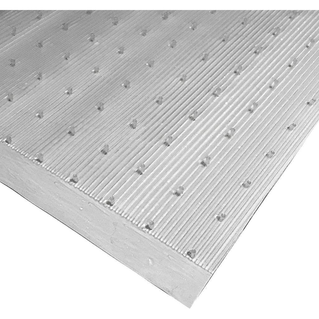 Corner of clear low pile carpet floor runner with the grippers showing
