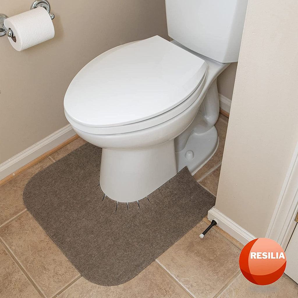 bathroom toilet with tan commode mat around the base of the toilet