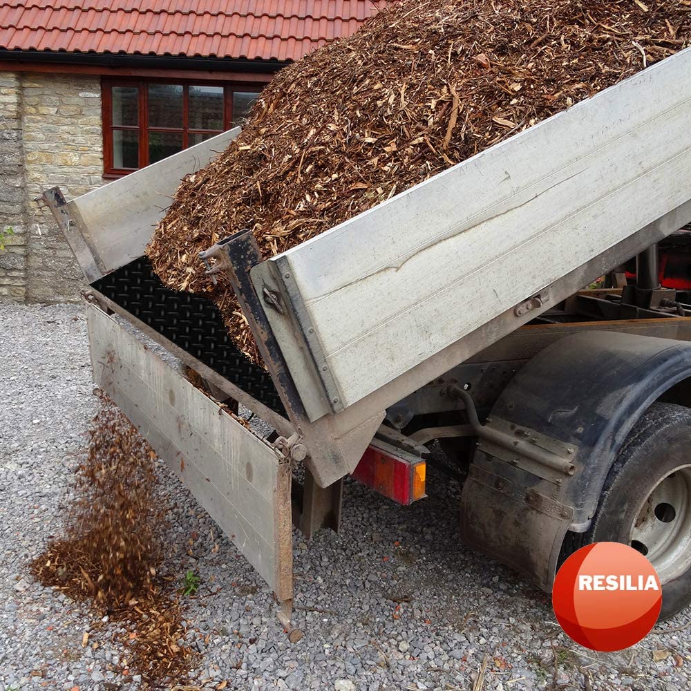  Wood chips being dumped from a truck lined with a truck bed mat liner