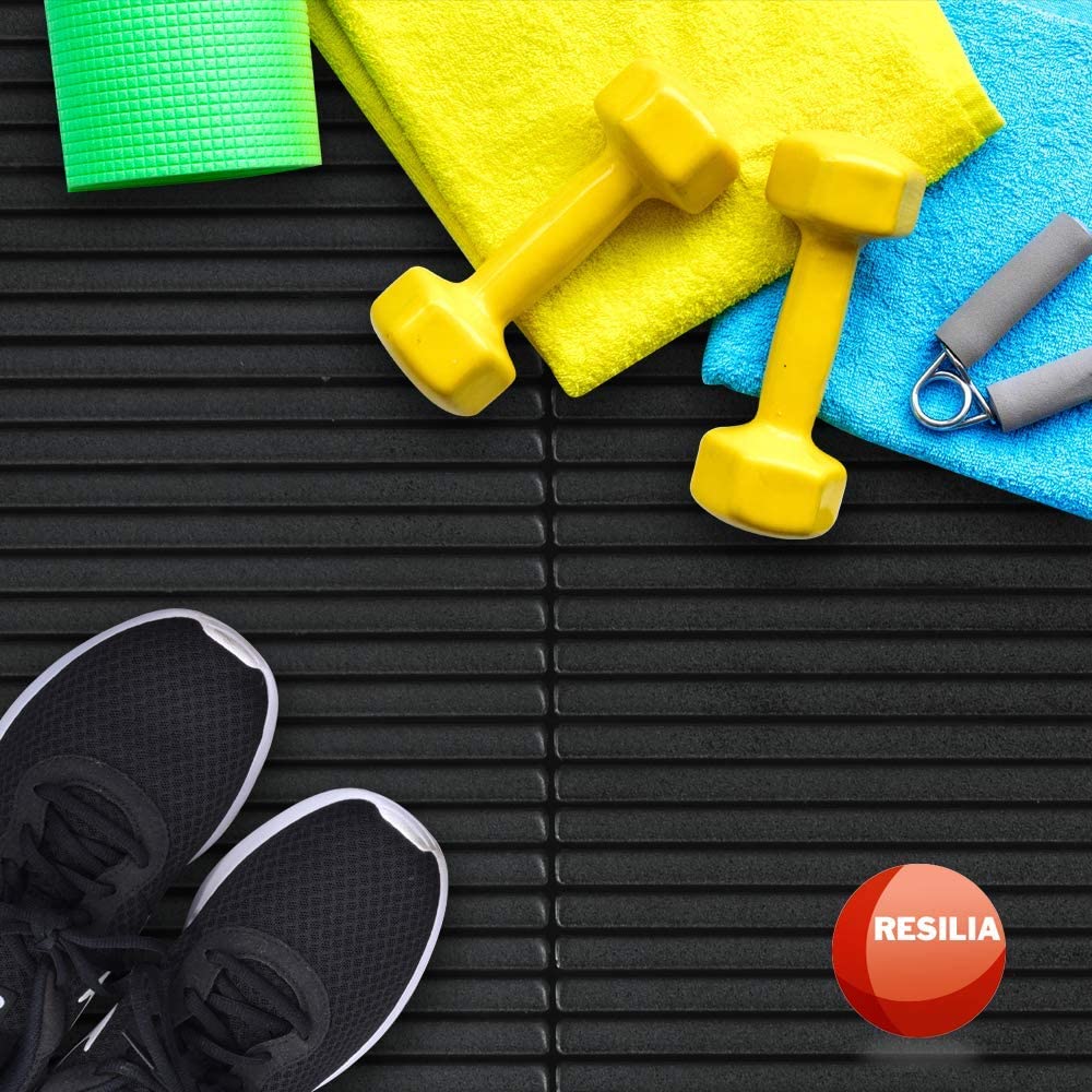 shoes, weights and towels on top of an exercise mat