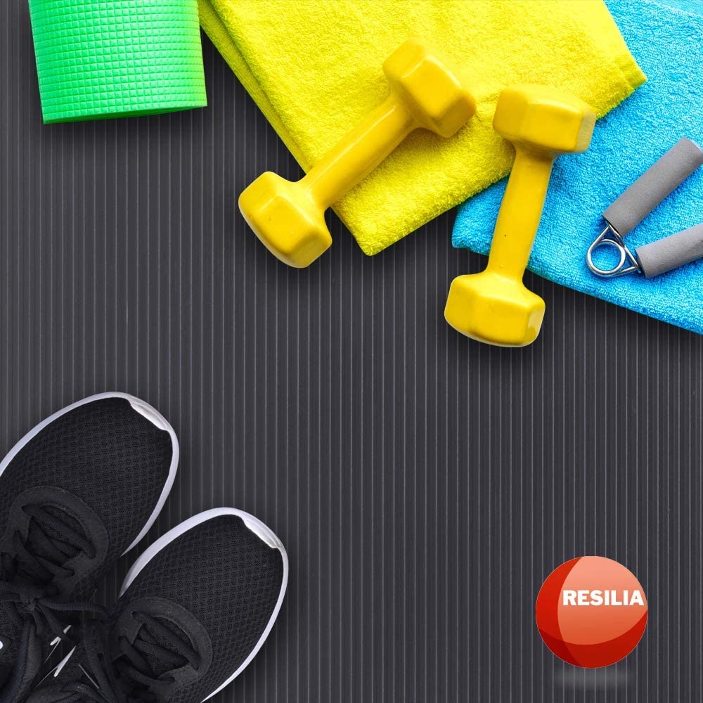 shoes, weights and towels on top of an exercise mat