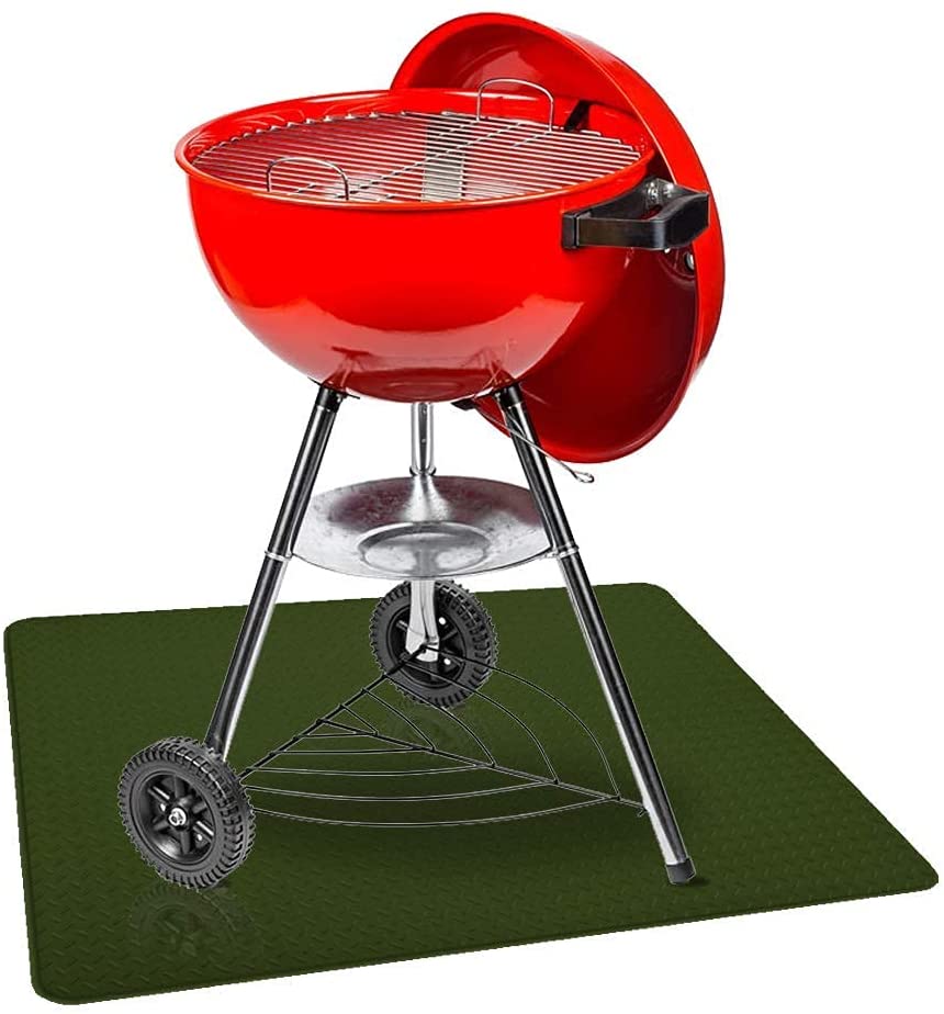 Smaller red charcoal grill on top of green grill mat with diamond plate