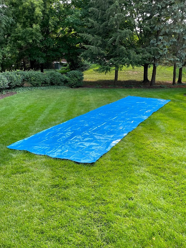 Full waterslide laid out in the backyard