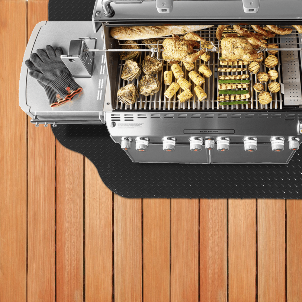Grill on grill mat on top of wooden deck for protection