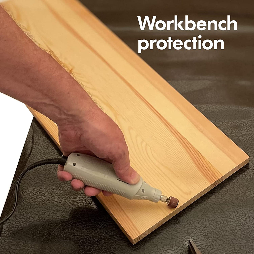 Workbench being protected by worker with sanding tool on the mat